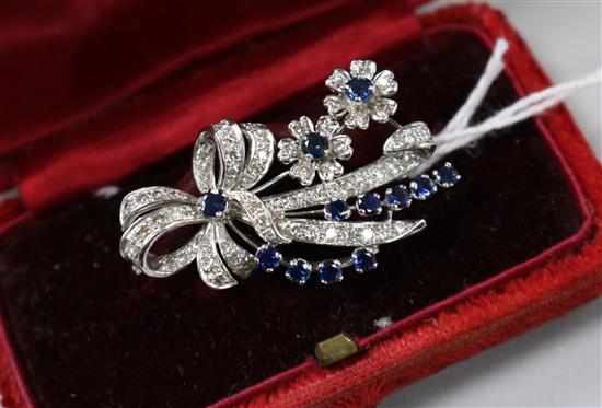 An 18ct white gold, sapphire and diamond ribbon bow and floral spray brooch, 4cm.